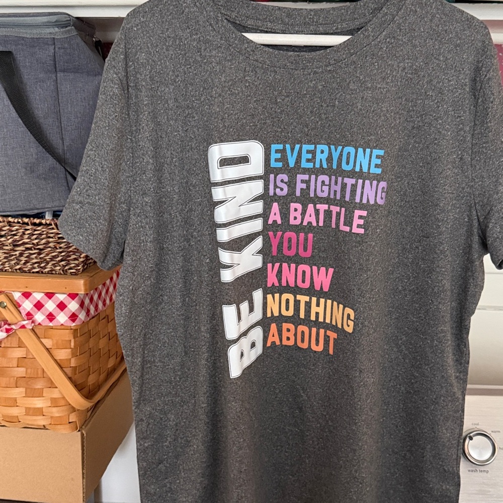 Nice new gray T-shirt. Never worn. Back is plain gray.